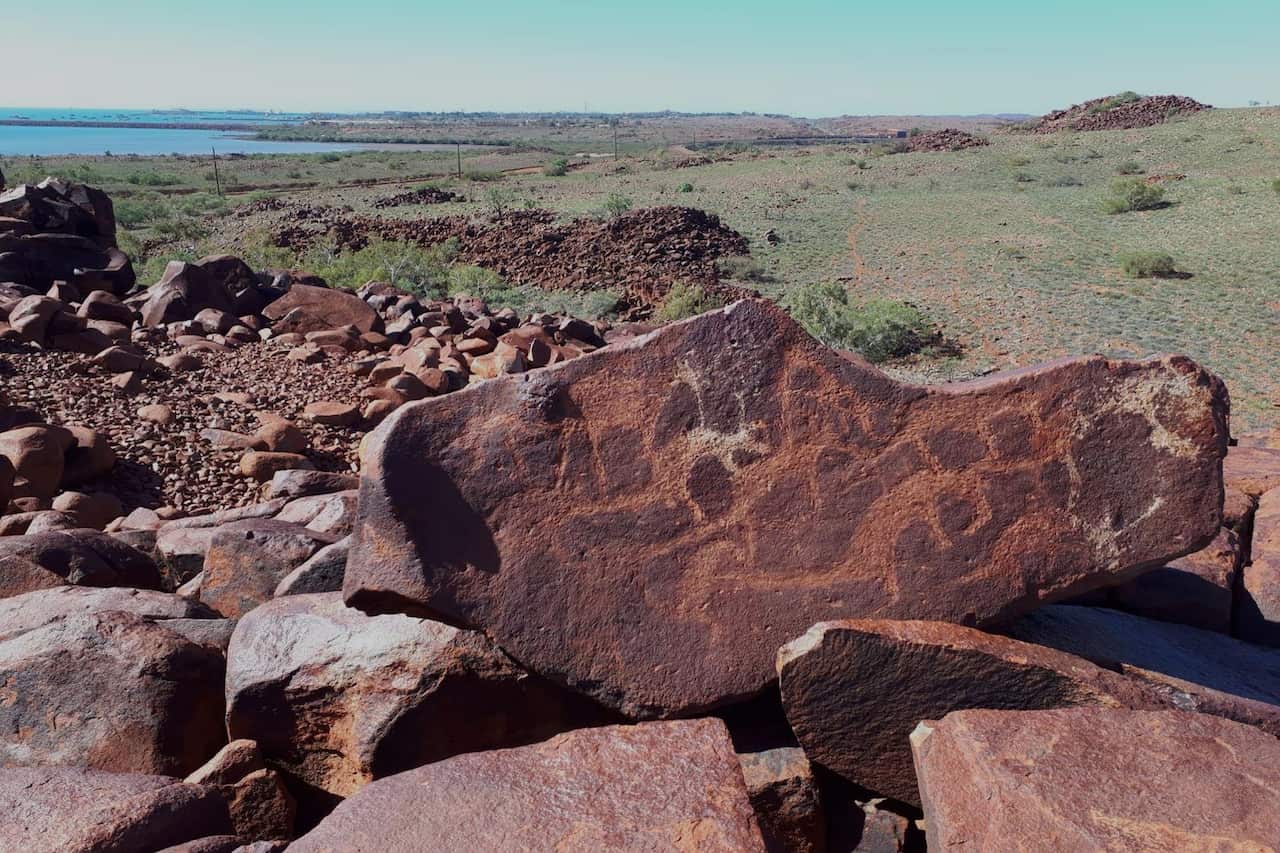 A piece of rock art among other rocks outside