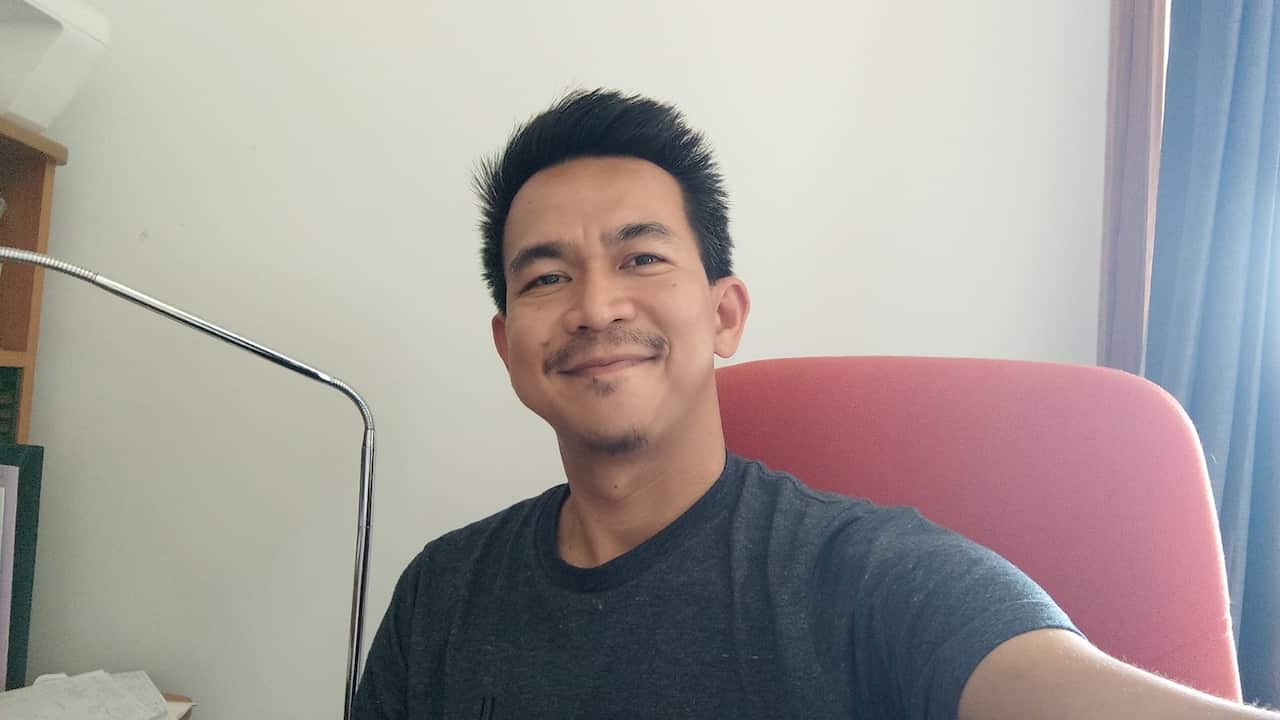 A man smiles for a selfie