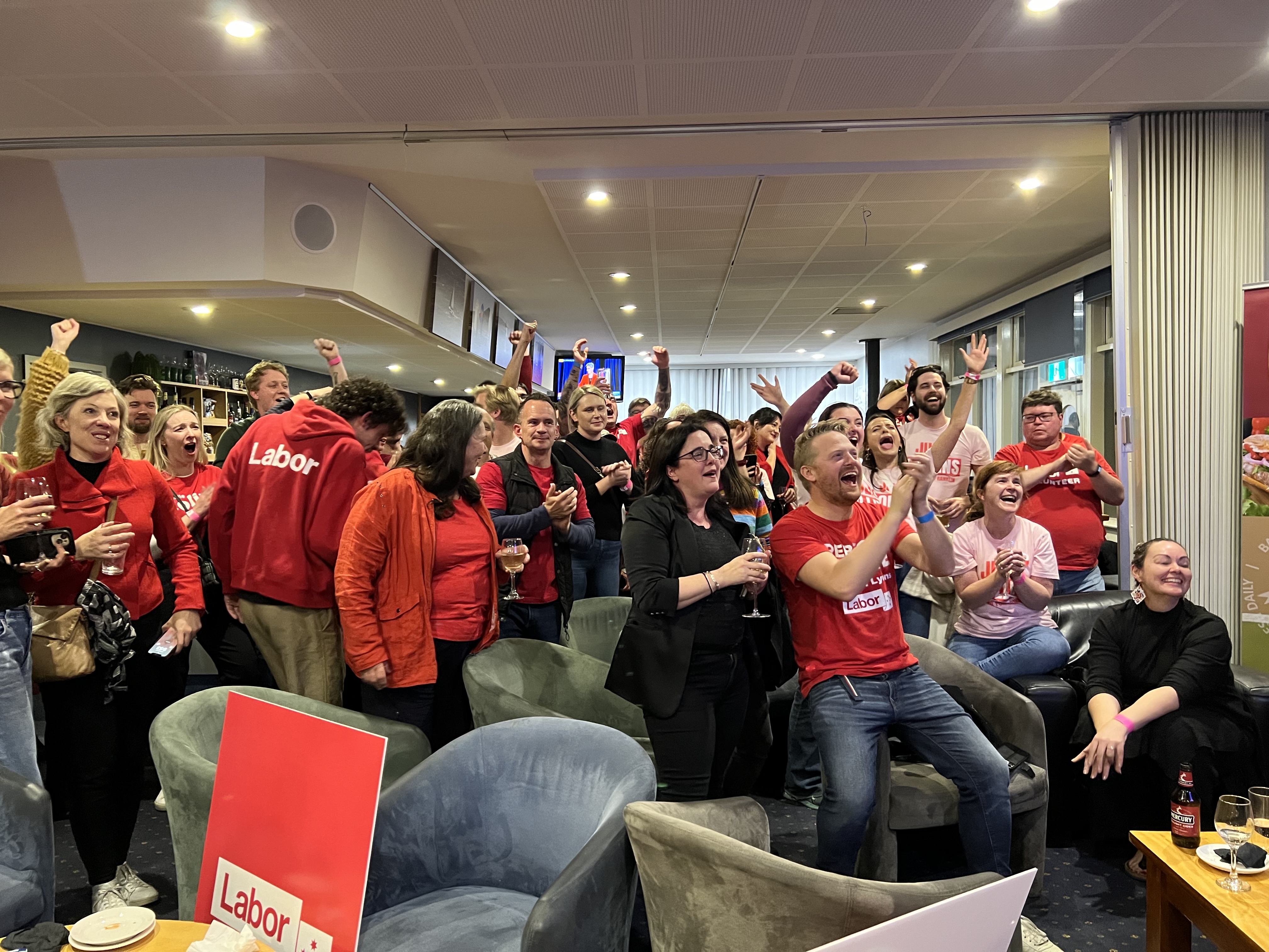 People wearing red celebrating.