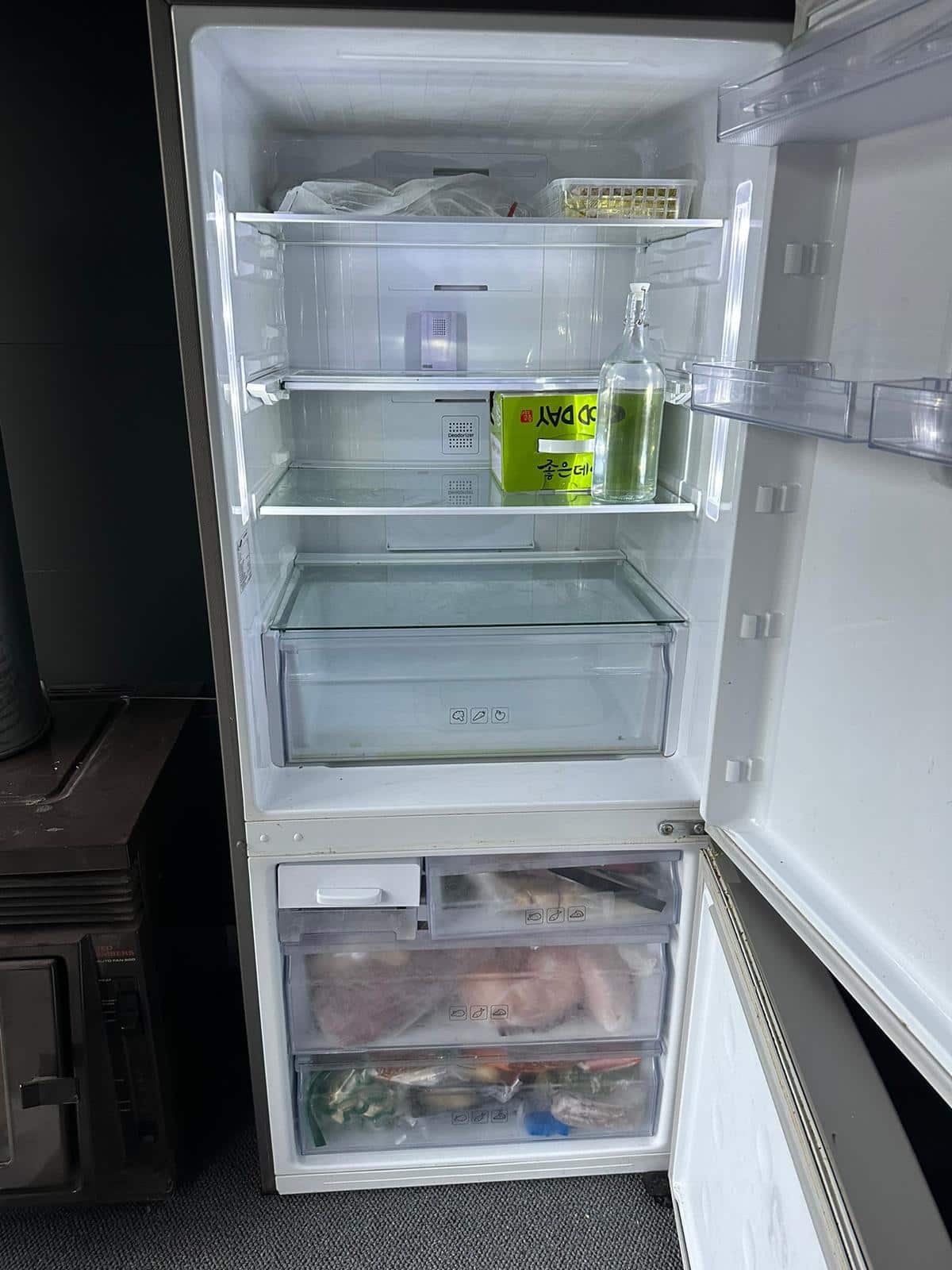 Almost empty fridge and full freezer