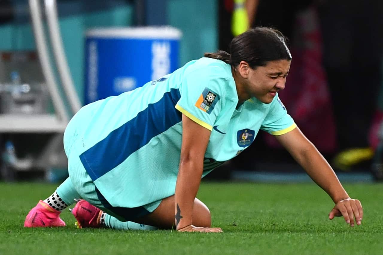 A woman in pain struggles on the ground.