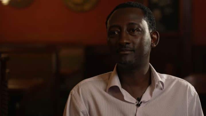 A man wearing a light-coloured shirt.