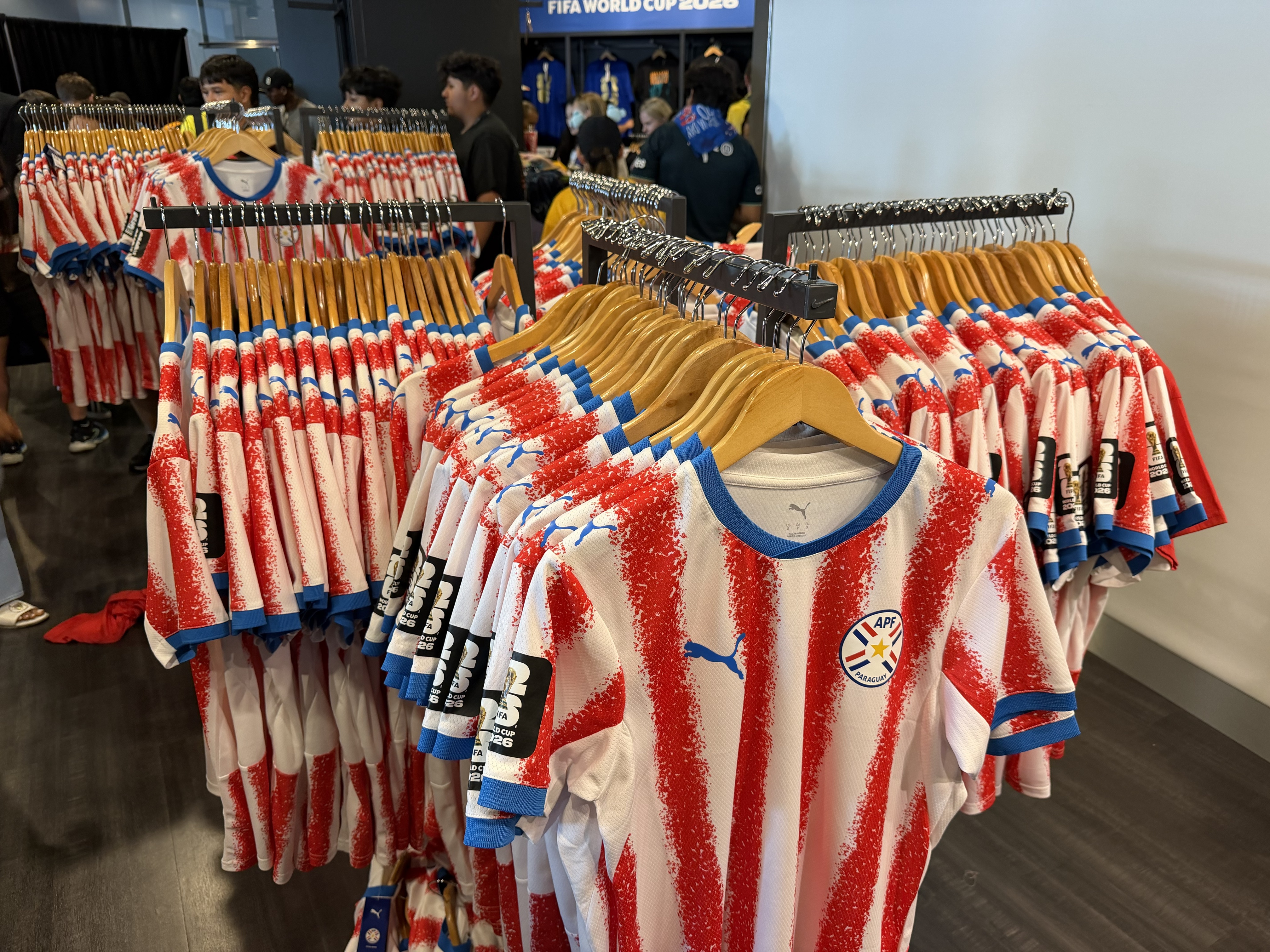 Paraguay merch shirts hanging on racks.