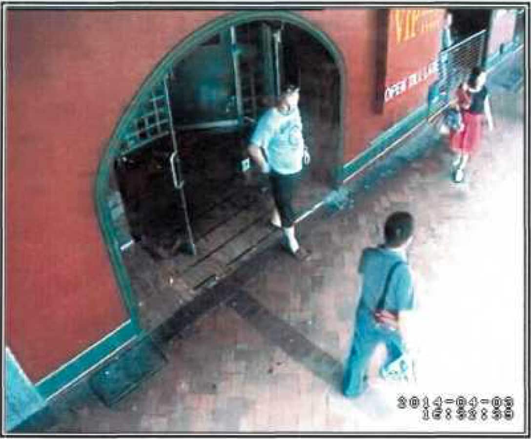 Aerial CCTV picture of a man walking out of a pub