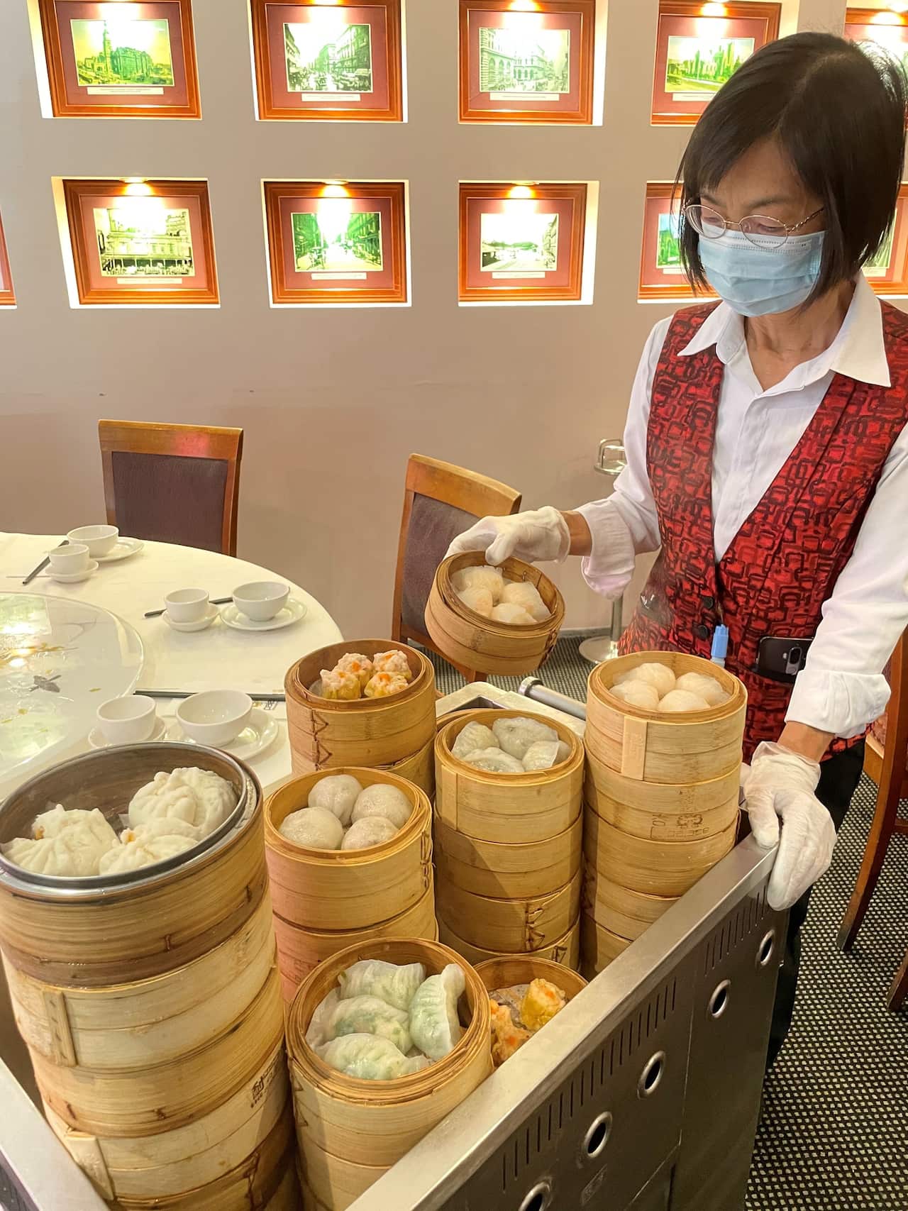 Waitress with her yum cha trolley.
