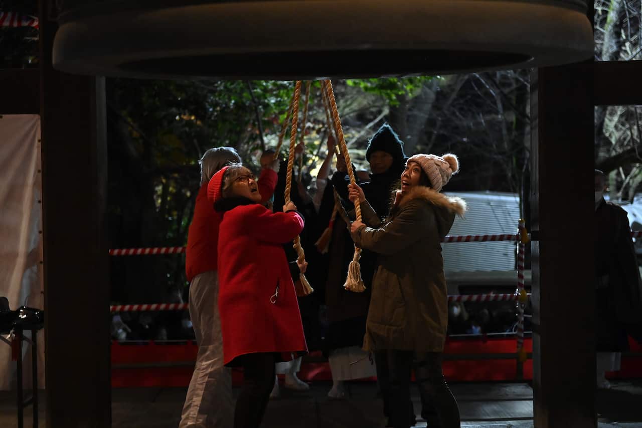 A group of people ringing bells