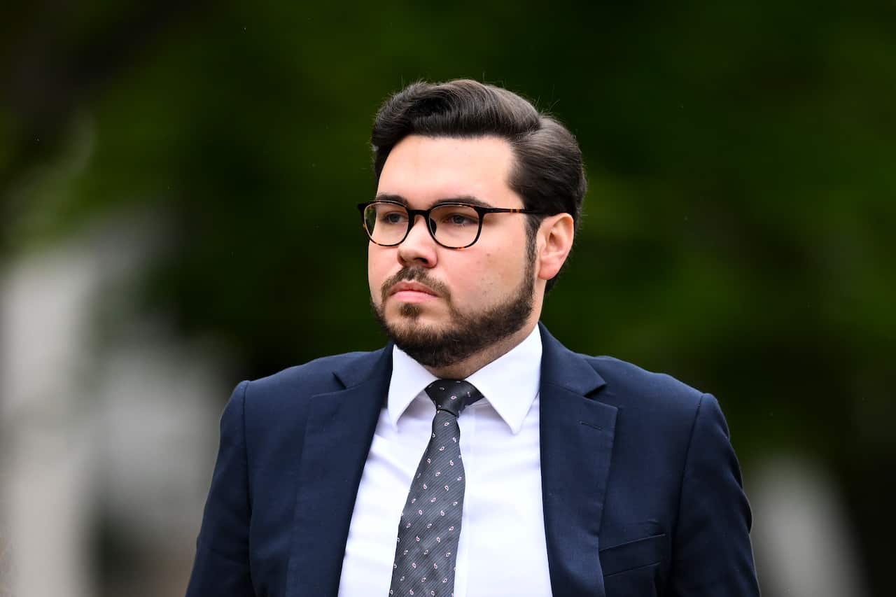 Bruce Lehrmann in a suit and tie outside