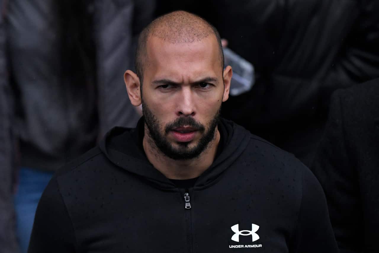 A bald man in a black hoodie