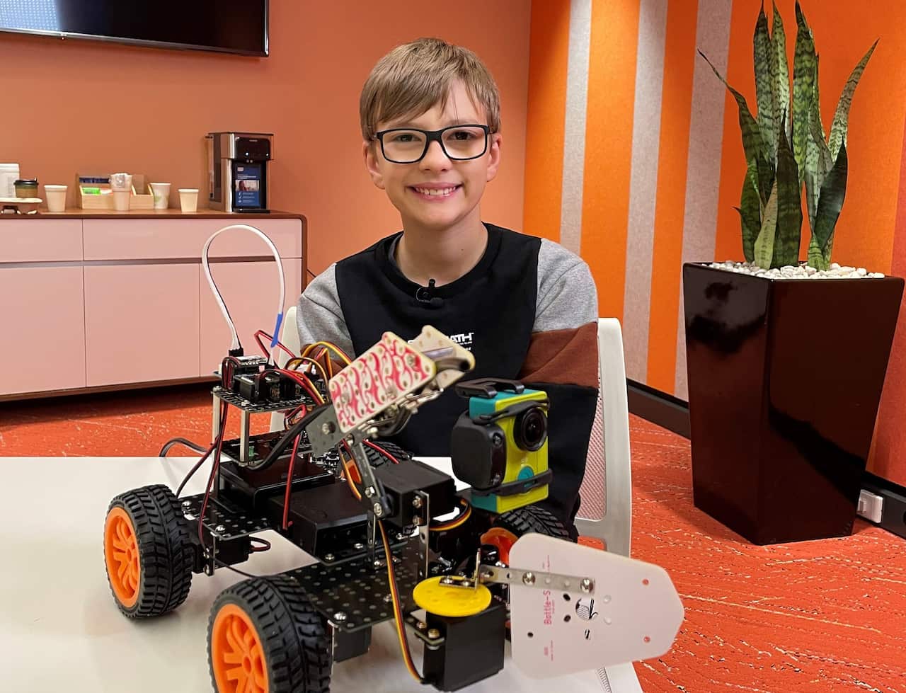 Harrison Ractivand, 12, with his award winning firefighting robot (SBS).jpg