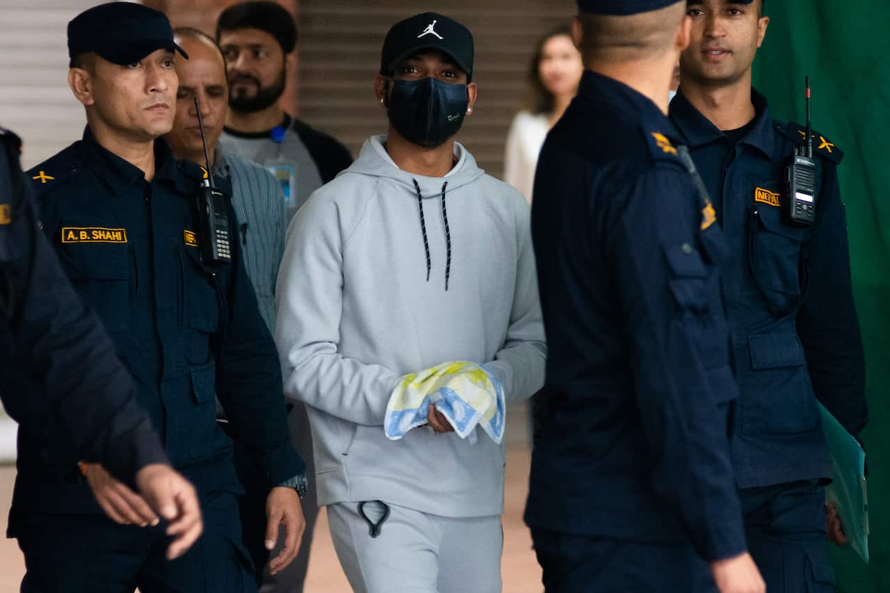 Former Nepali national cricket team captain Sandeep Lamichhane (C) was detained upon his arrival at Tribhuwan International Airport in Kathmandu, Nepal on Thursday, October 6, 2022. 