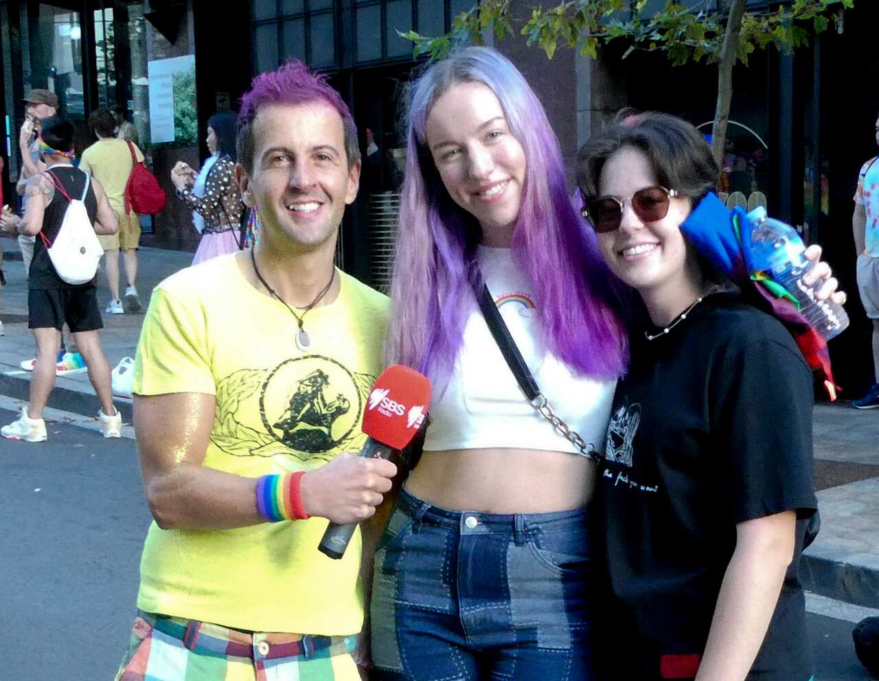 Two Pride marchers with SBS Italian journalist