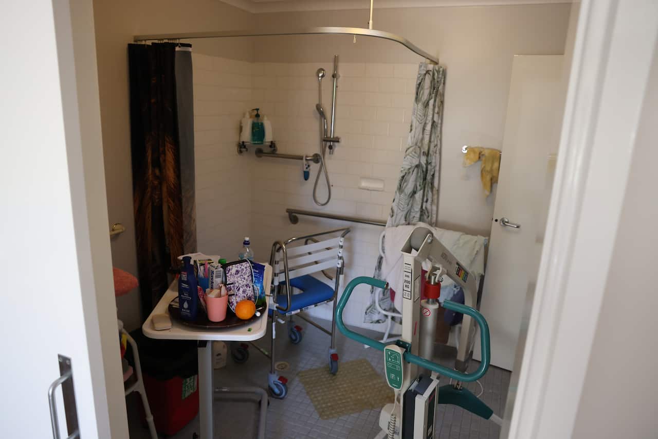 A shower set up with disability support equipment
