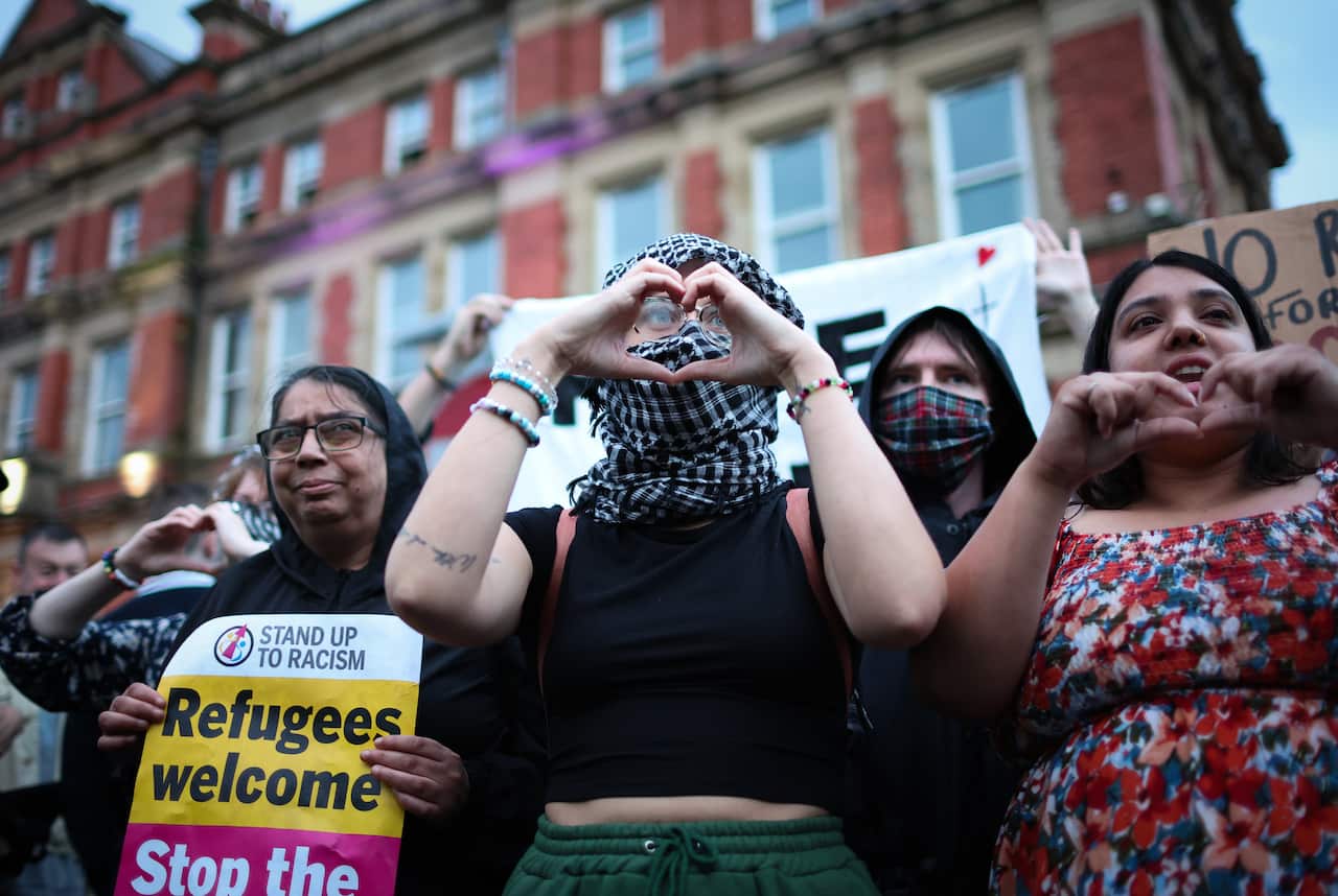 People demonstrate to defend Liverpool mosque from the threat of far-right attacks