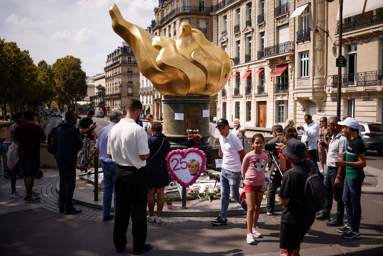 People gather by the Liberty Flame above the Alma Tunnel to pay tribute to late Princess Diana, in Paris, on 31 August, 2022.  