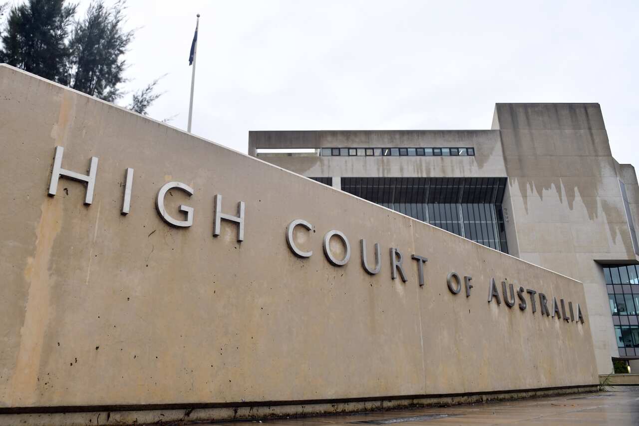 A sign out the front of a building that reads: "High Court of Australia".