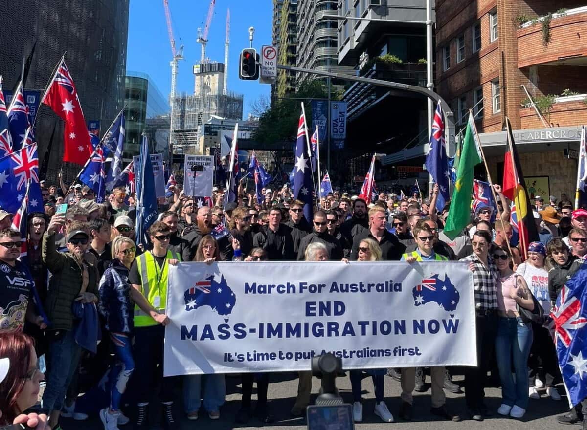 A large group of people holding a banner that says "March for Australia - end mass-immigration now".