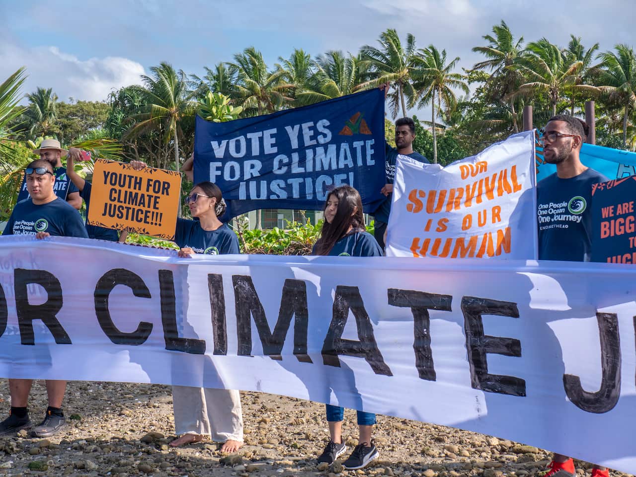 Climate activists holding banner.