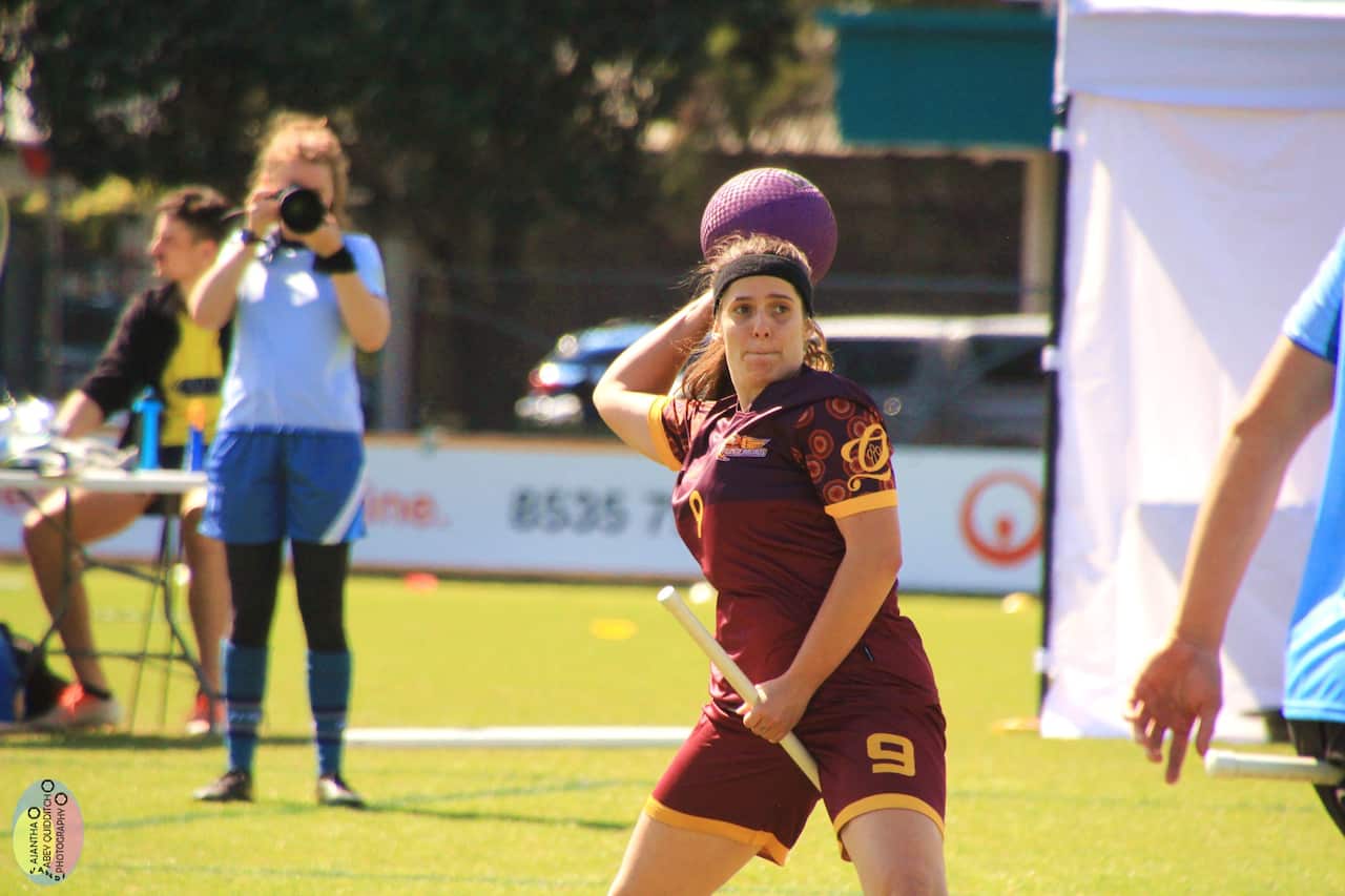 A player throws a ball during a quidditch match. 