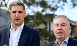 Matthew Pavlich and Andrew Pridham standing next to each other. Pridham is speaking.