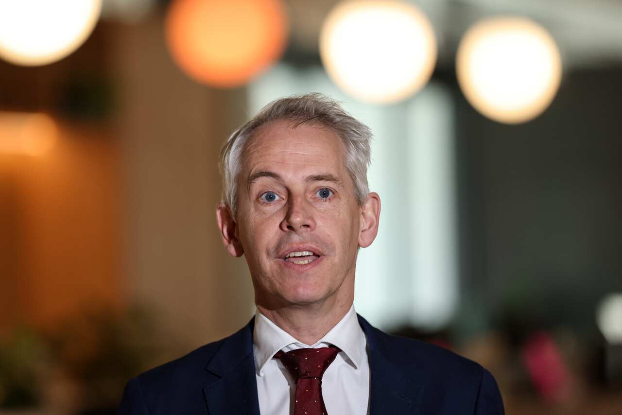 Man in a suit speaking.