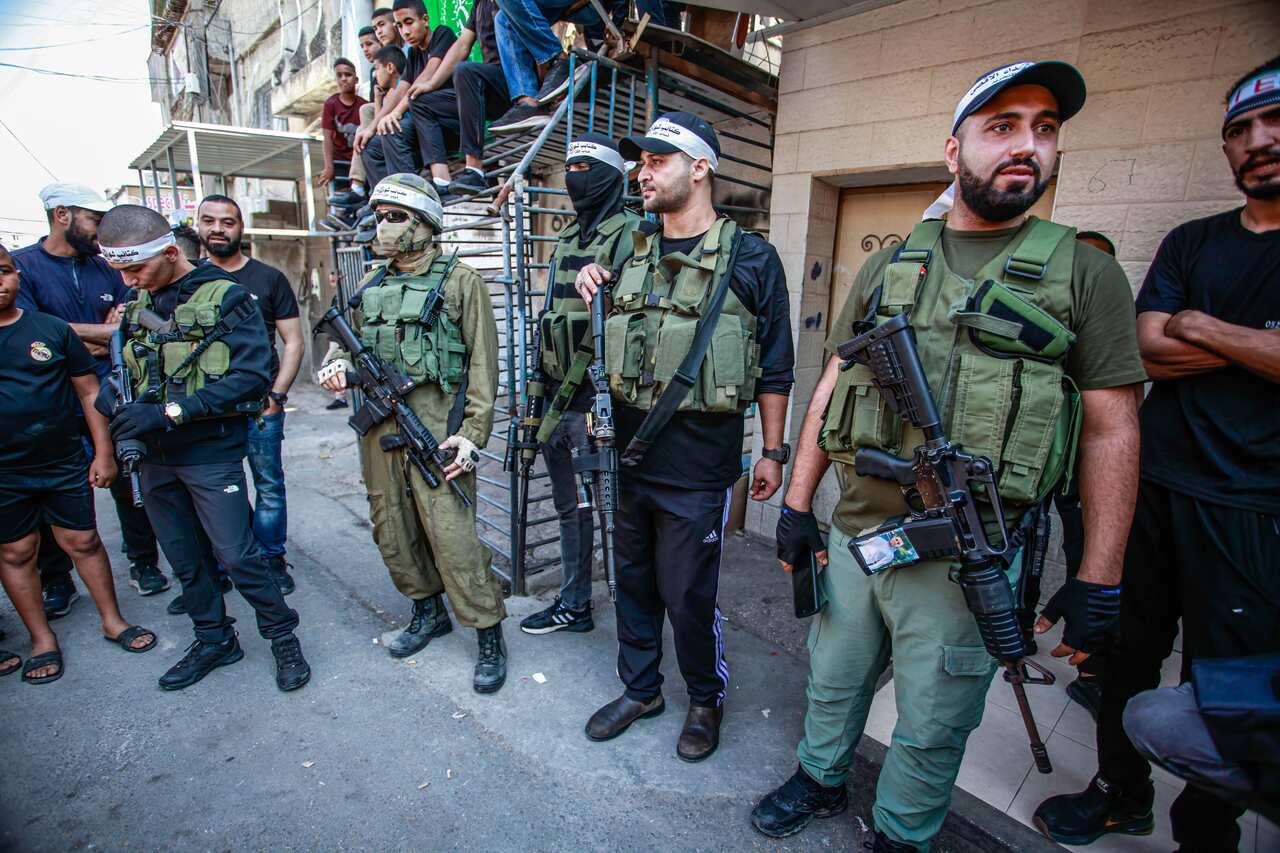 Men standing in a line wearing guns and armour