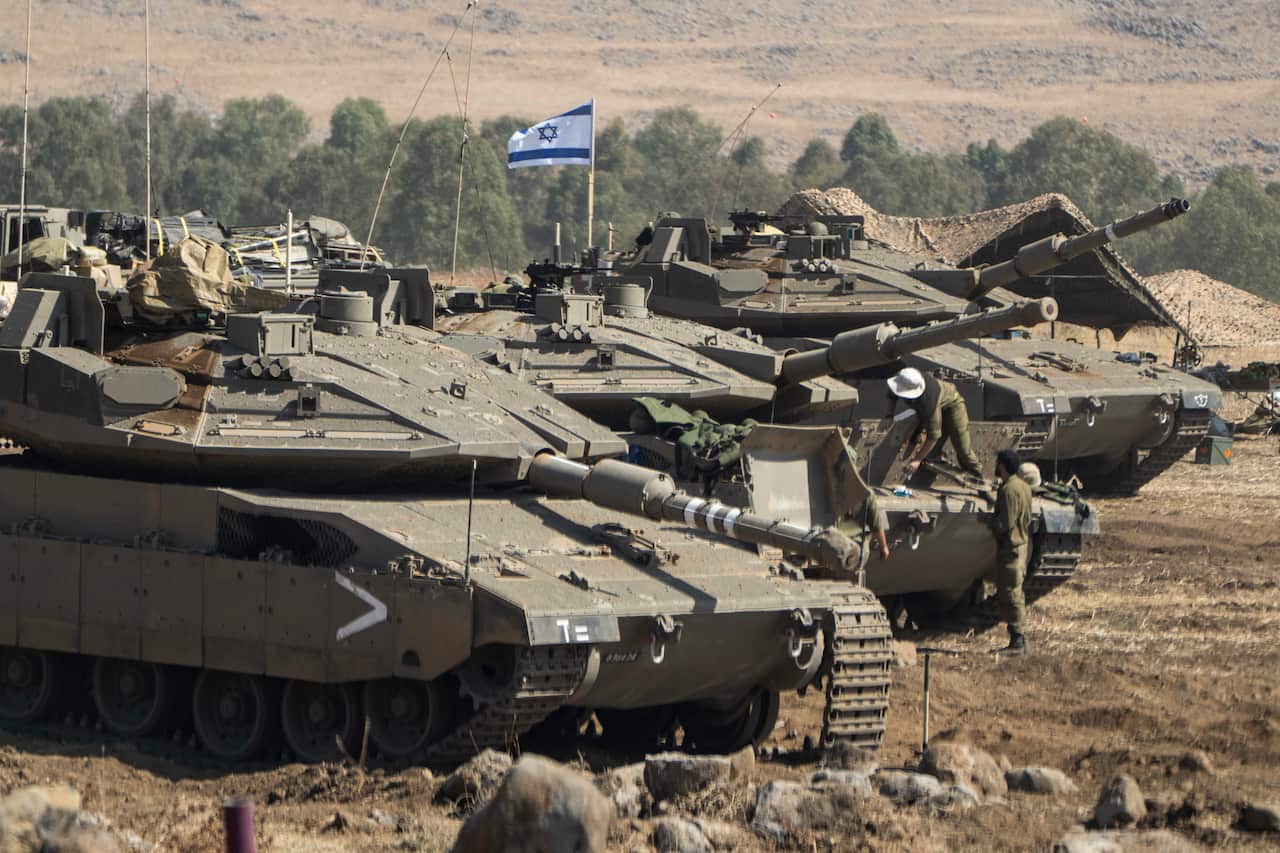 Israeli tanks are stationed near the border with Lebanon