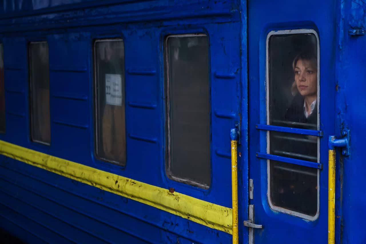 A conductor waits inside a train at the train station in Kyiv,