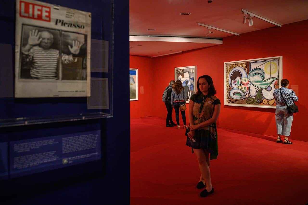 People look at works of art on display at the exhibition at the Brooklyn Museum.