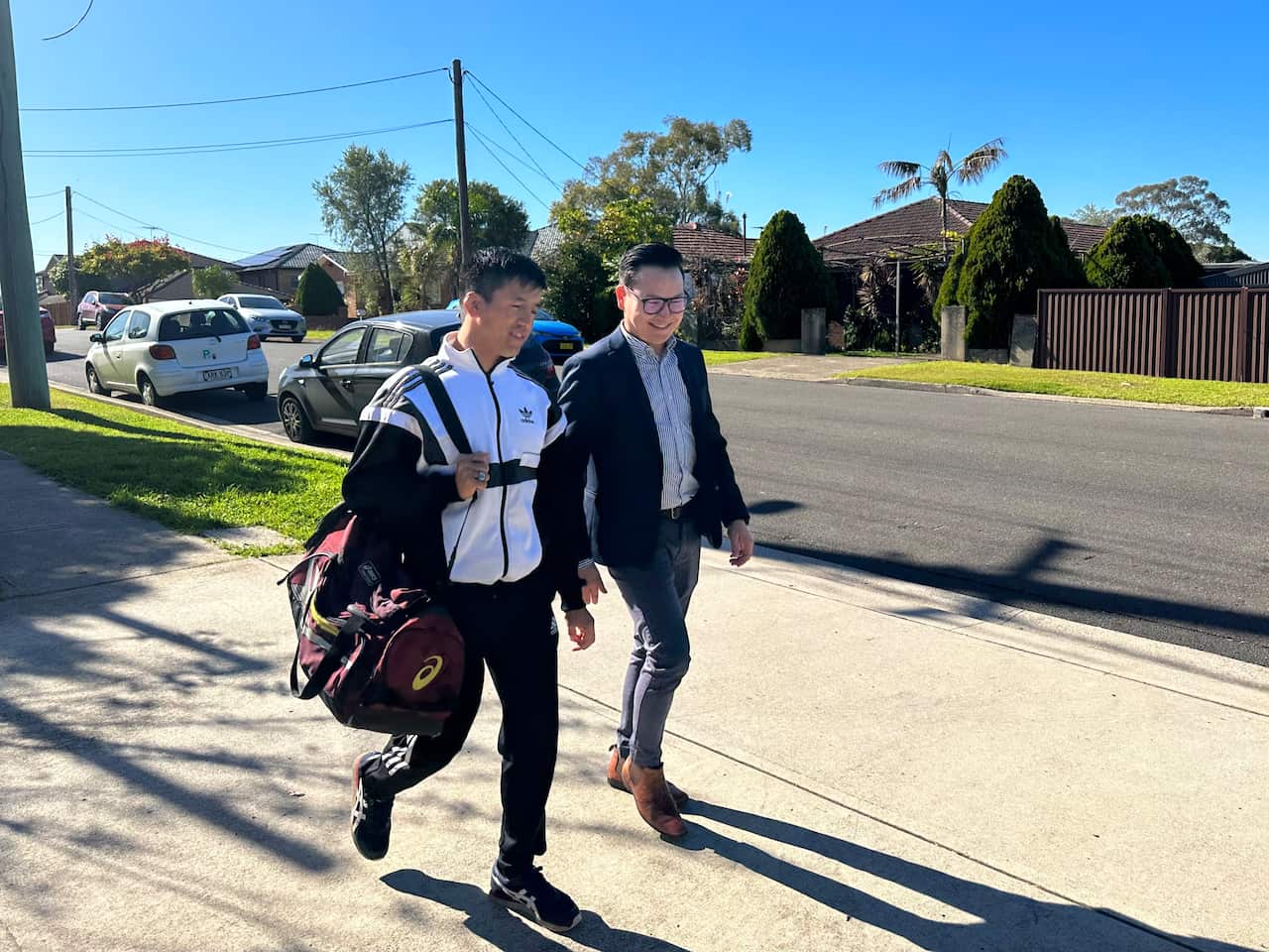 Two men walking together on a street
