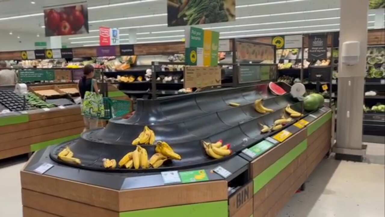 The produce section of a supermarket running low on fruits and vegetables