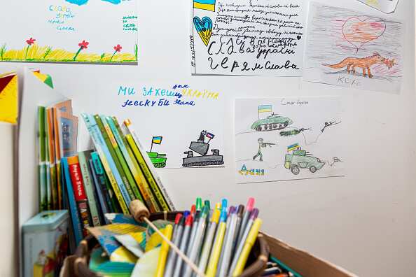 Children's drawings stuck to a wall