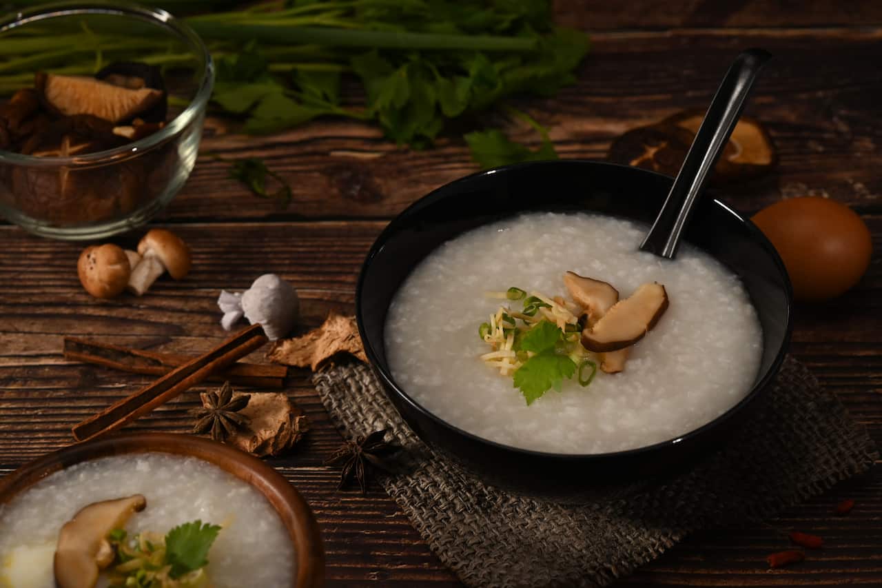 Bowl of congee or rice porridge with shiitake mushroom, slice gi