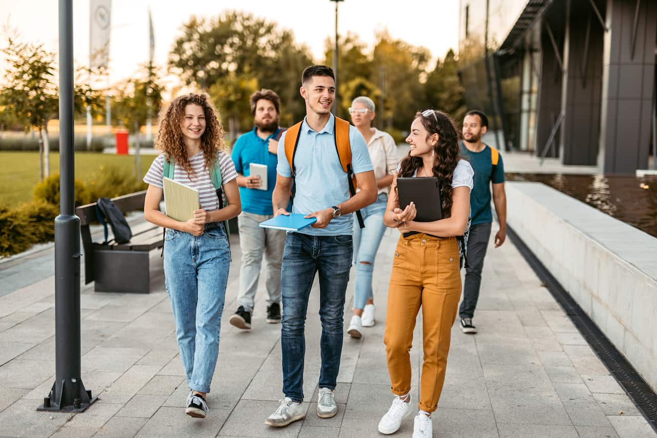 Students Walking  On The University Campus