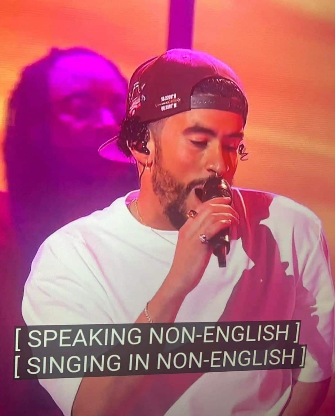 Man sings and there are closed captions. 