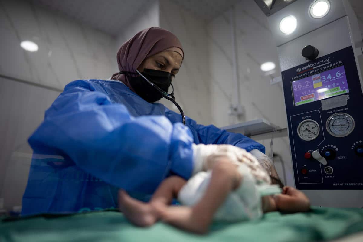 Idlib, Syria - Dr. Nawjan attends to a newborn baby 