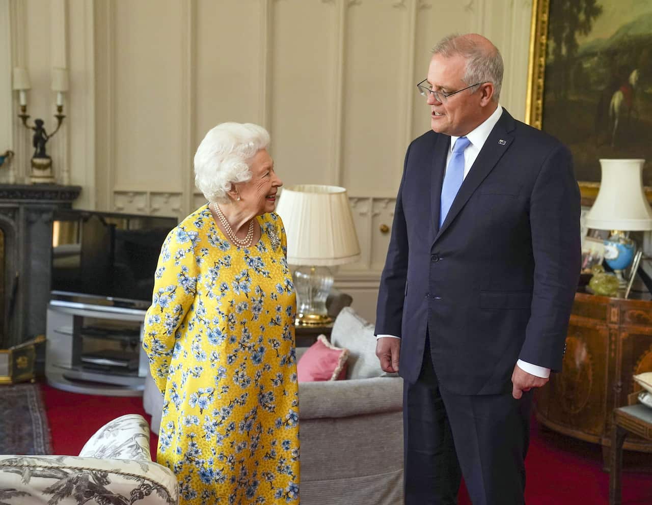Queen Elizabeth (left) and Scott Morrison (right) stand chat in a room in Windsor Castle.