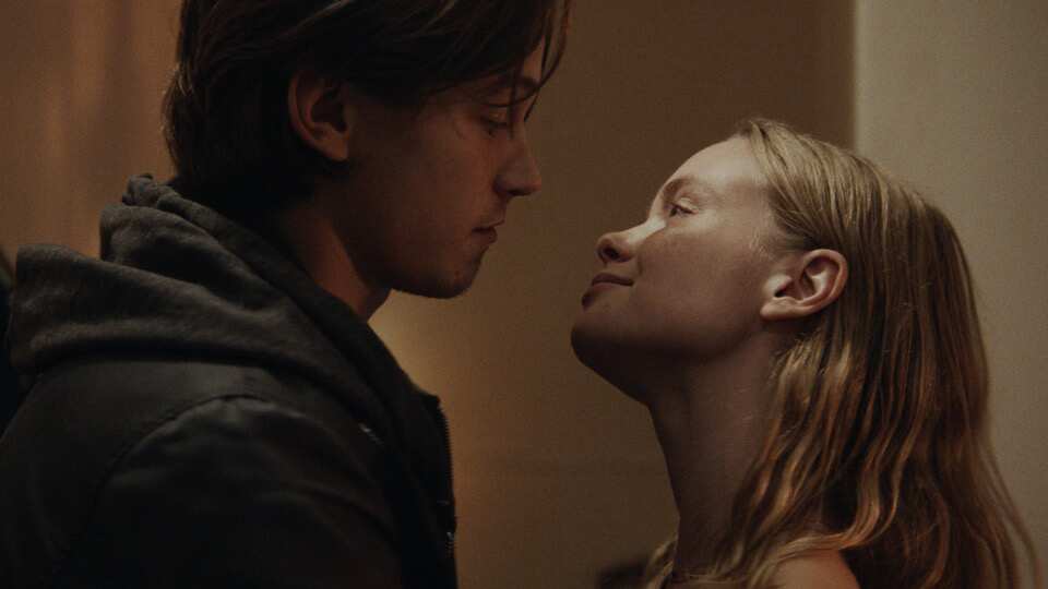 A woman looks up at a man smiling