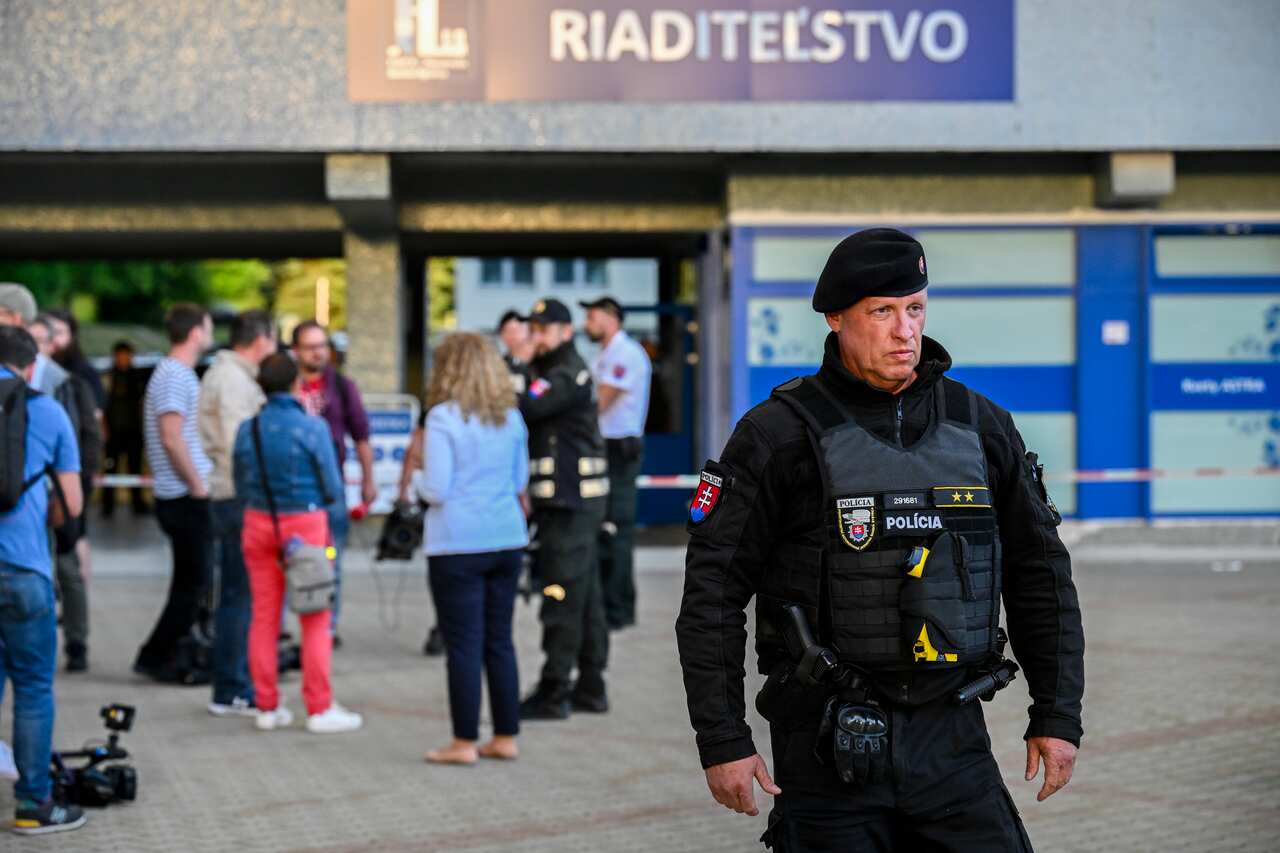 A police officer stands in the foreground
