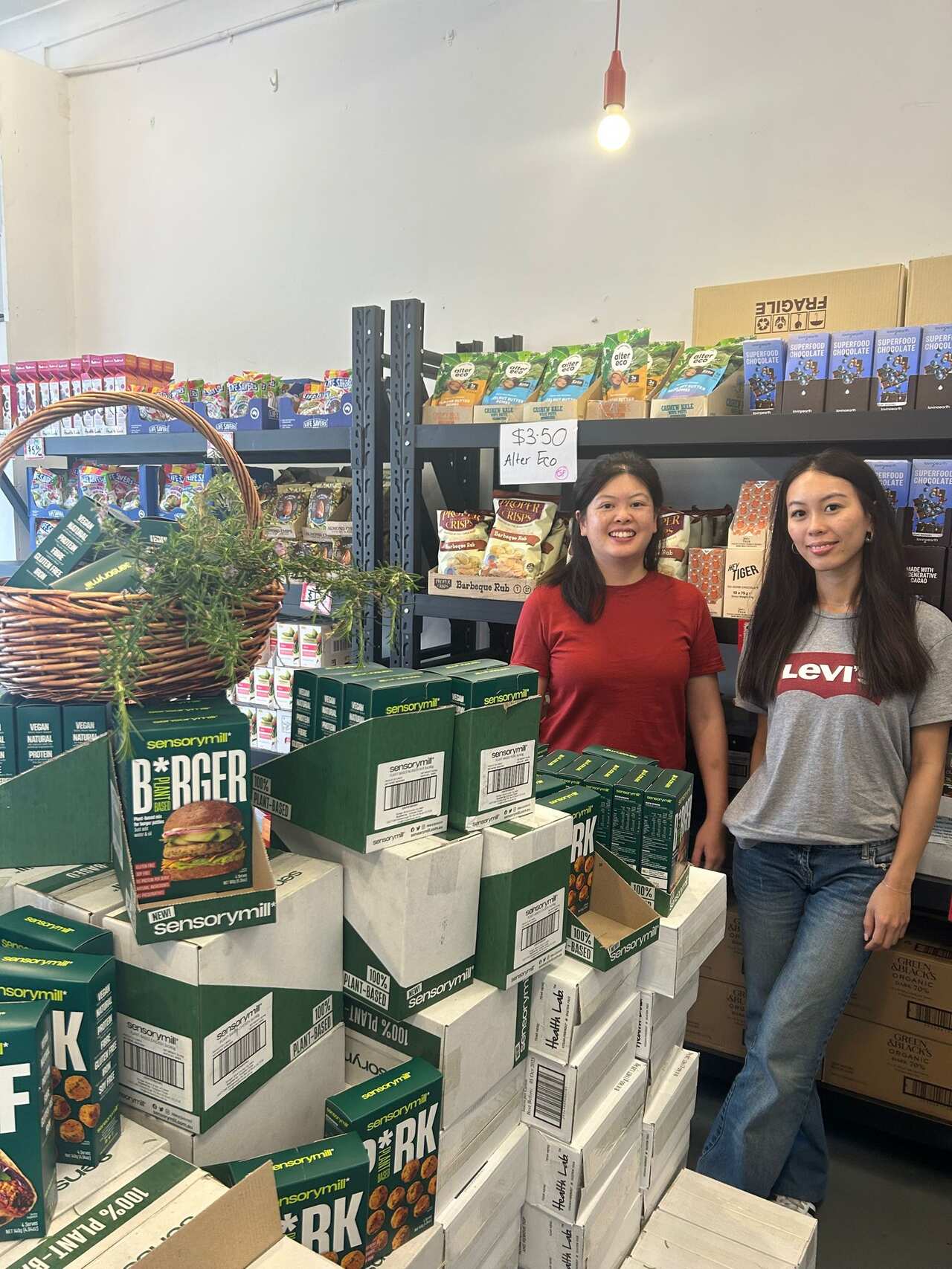 Two women standing in a grocery store.
