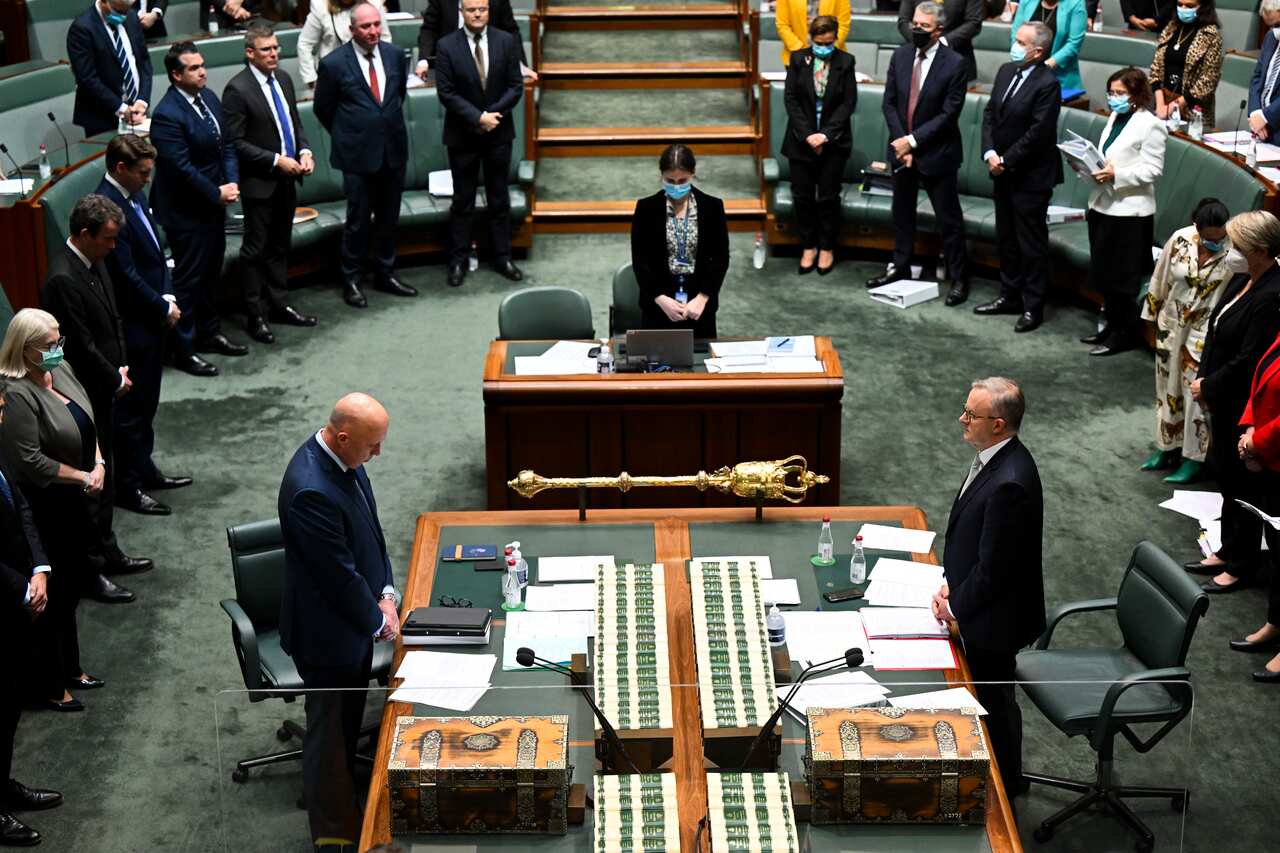 Parliamentarians mark a minute silence in the House of Representatives chamber. 