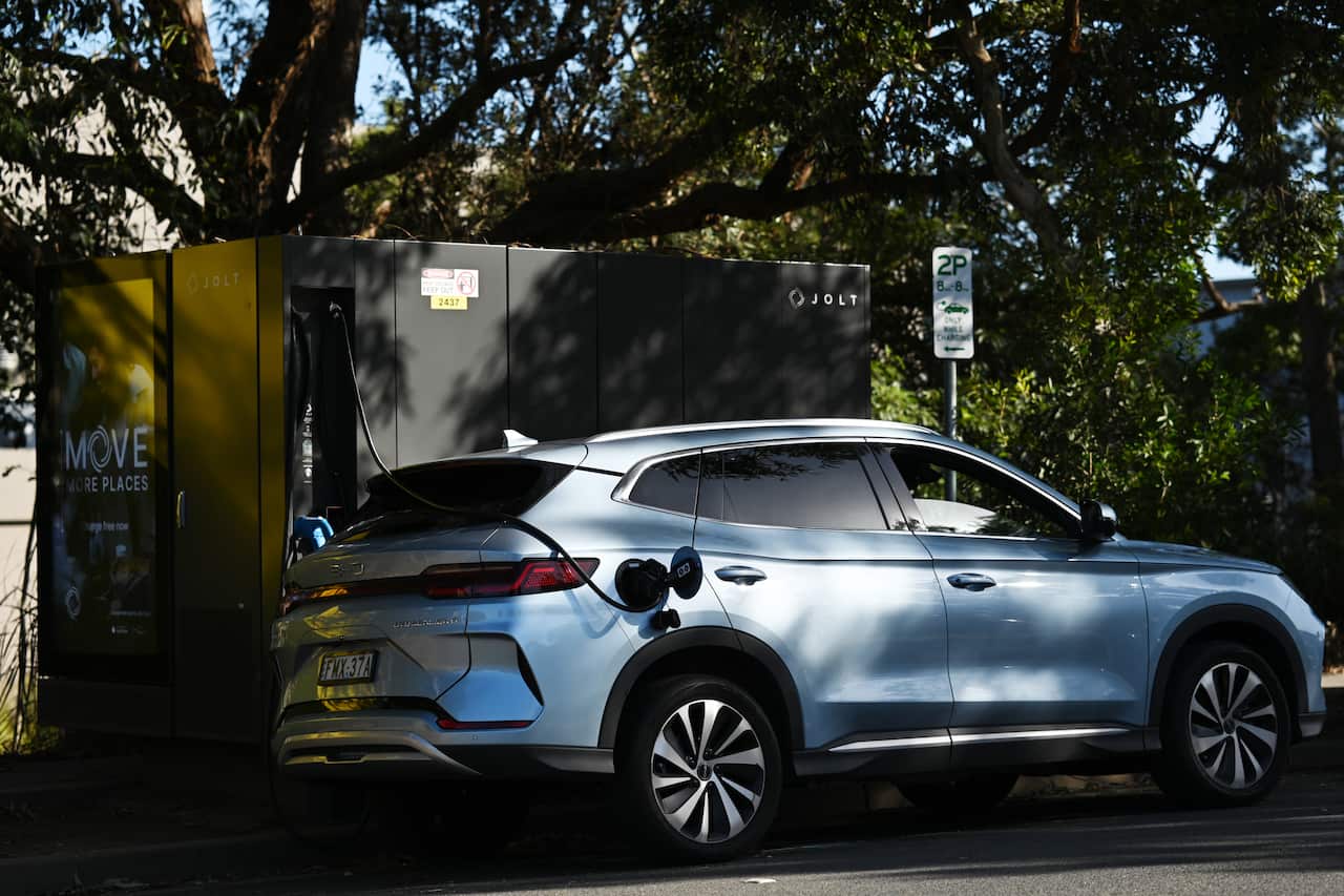 An EV being charged using a street charger.
