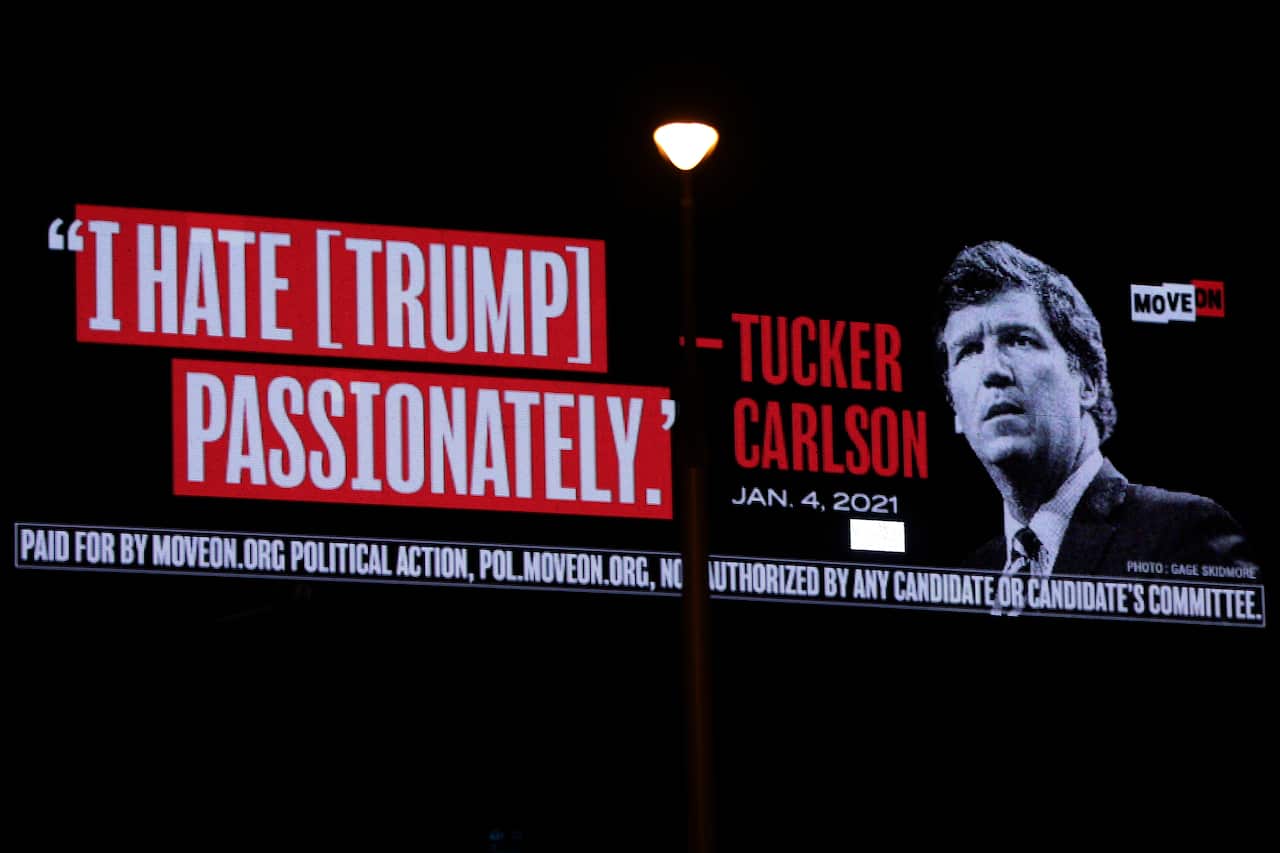 A billboard put up by progressive activist group MoveOn that read “I Hate [Trump] Passionately - Tucker Carlson” 