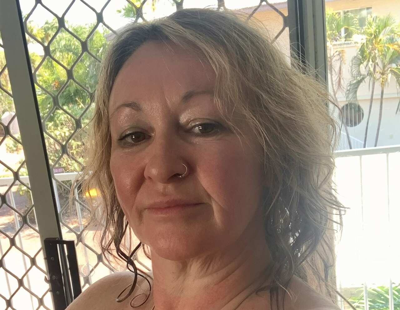 A selfie of a middle-aged blonde woman.