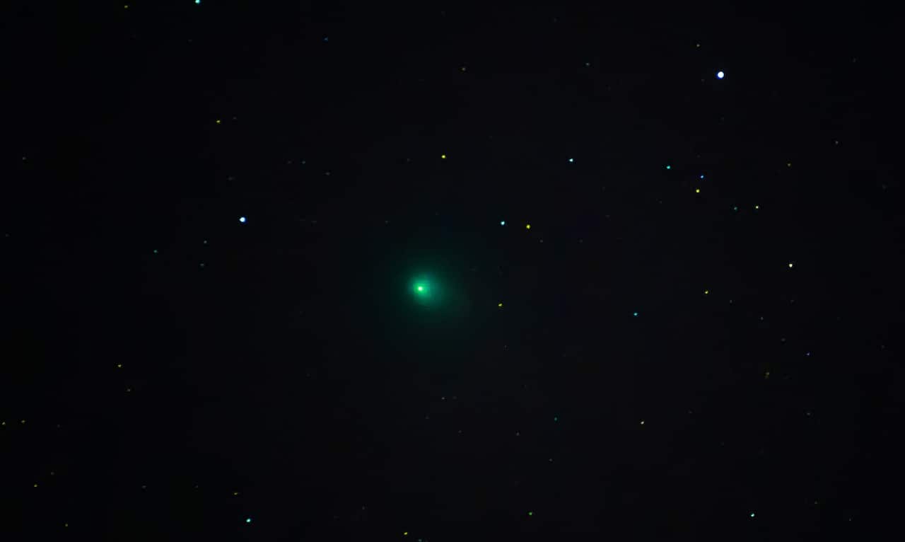 A large green dot in the night sky