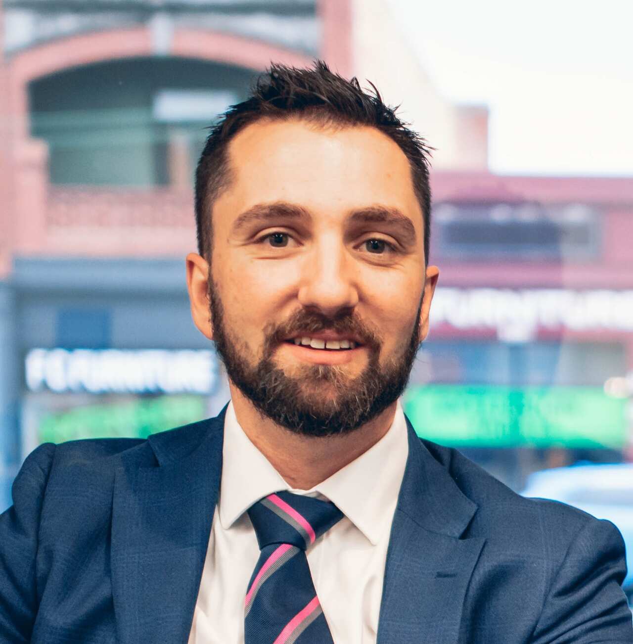 Headshot of a man in a suit