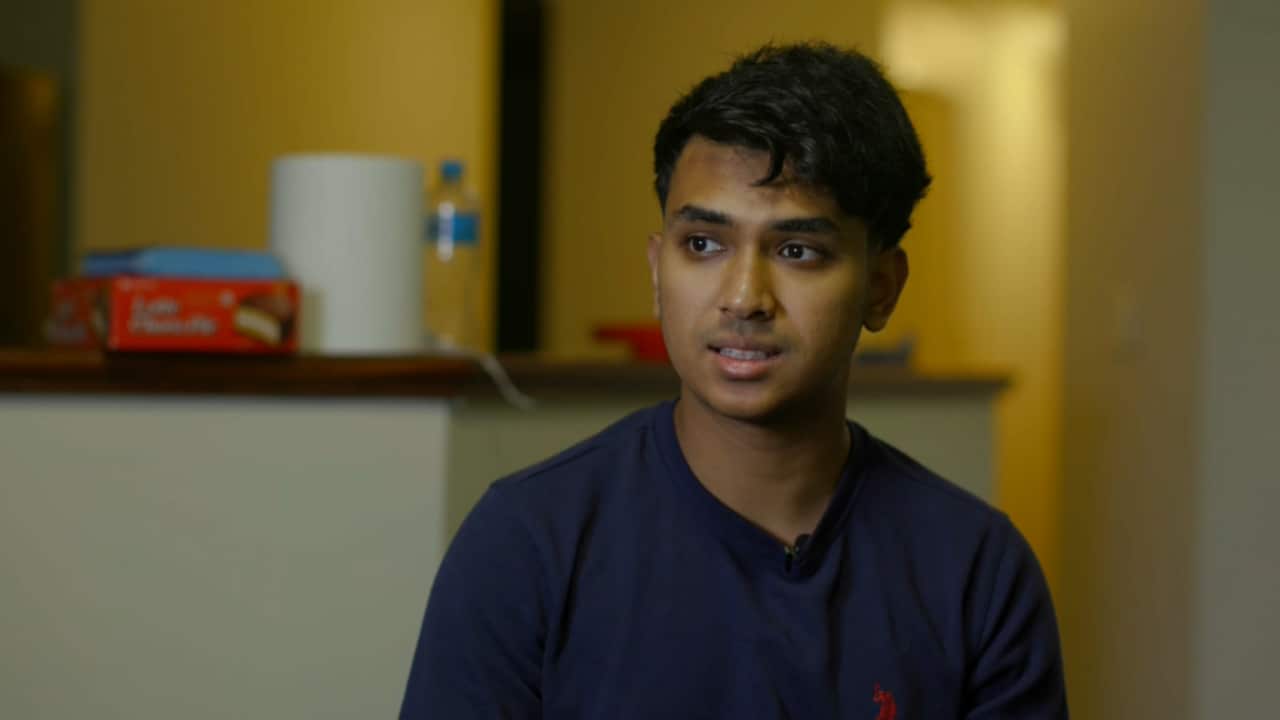 A man speaking to a camera.