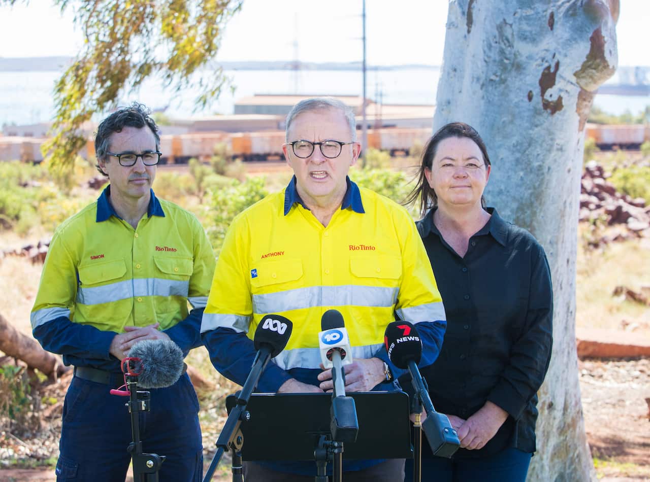 Wearing a hi-vis work shirt, Anthony Albanese speaks at press conference