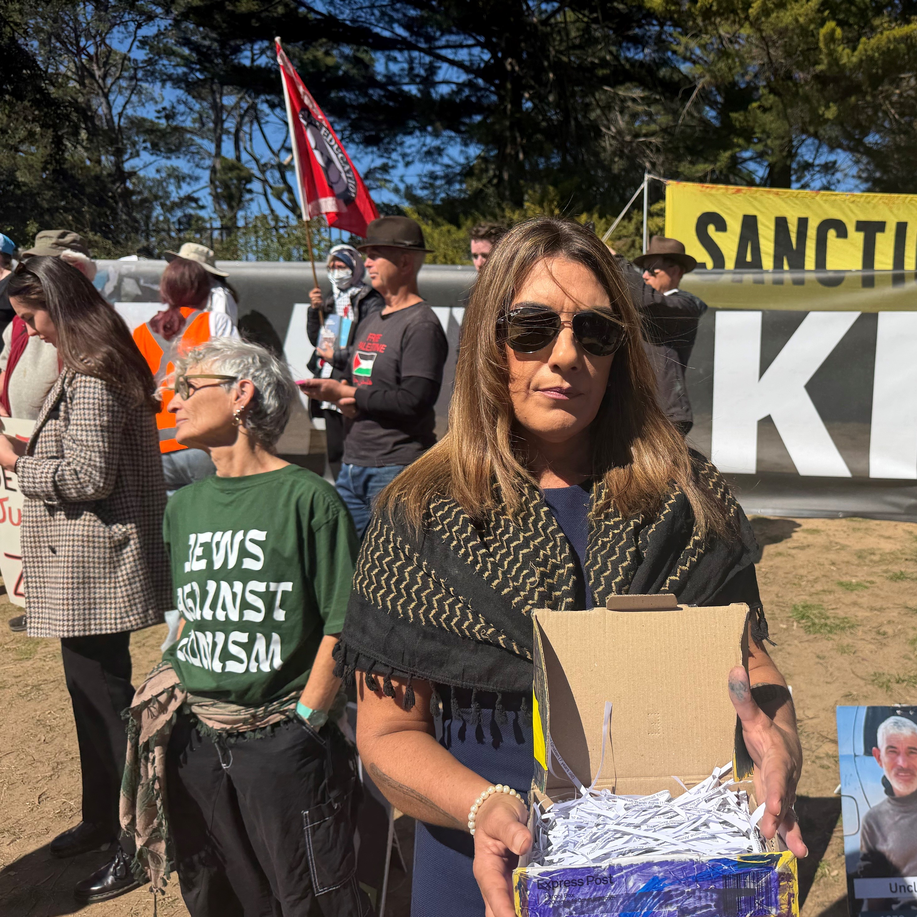 A woman carrying a box at a protest