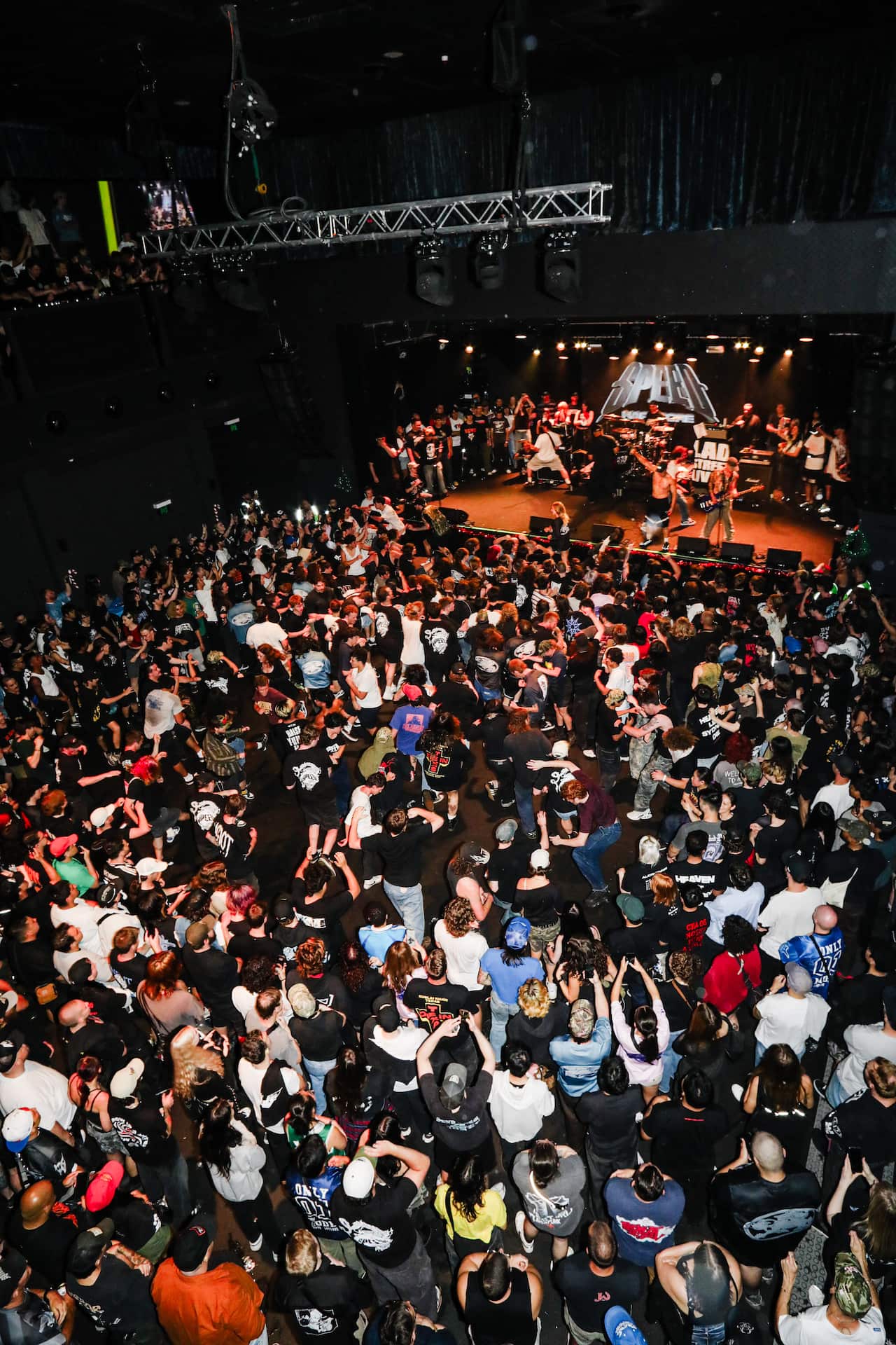 A crowd dancing at a concert.