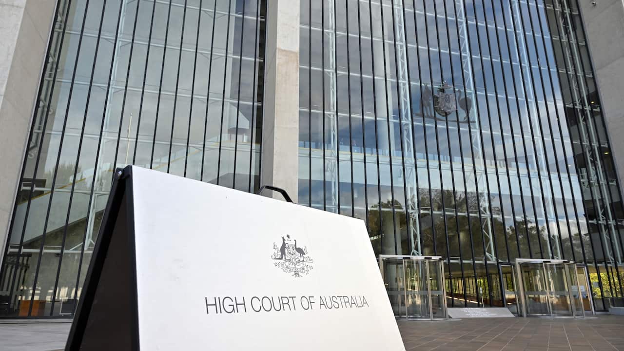 The exterior of the High Court of Australia, with a small sign out front reading "High Court of Australia".